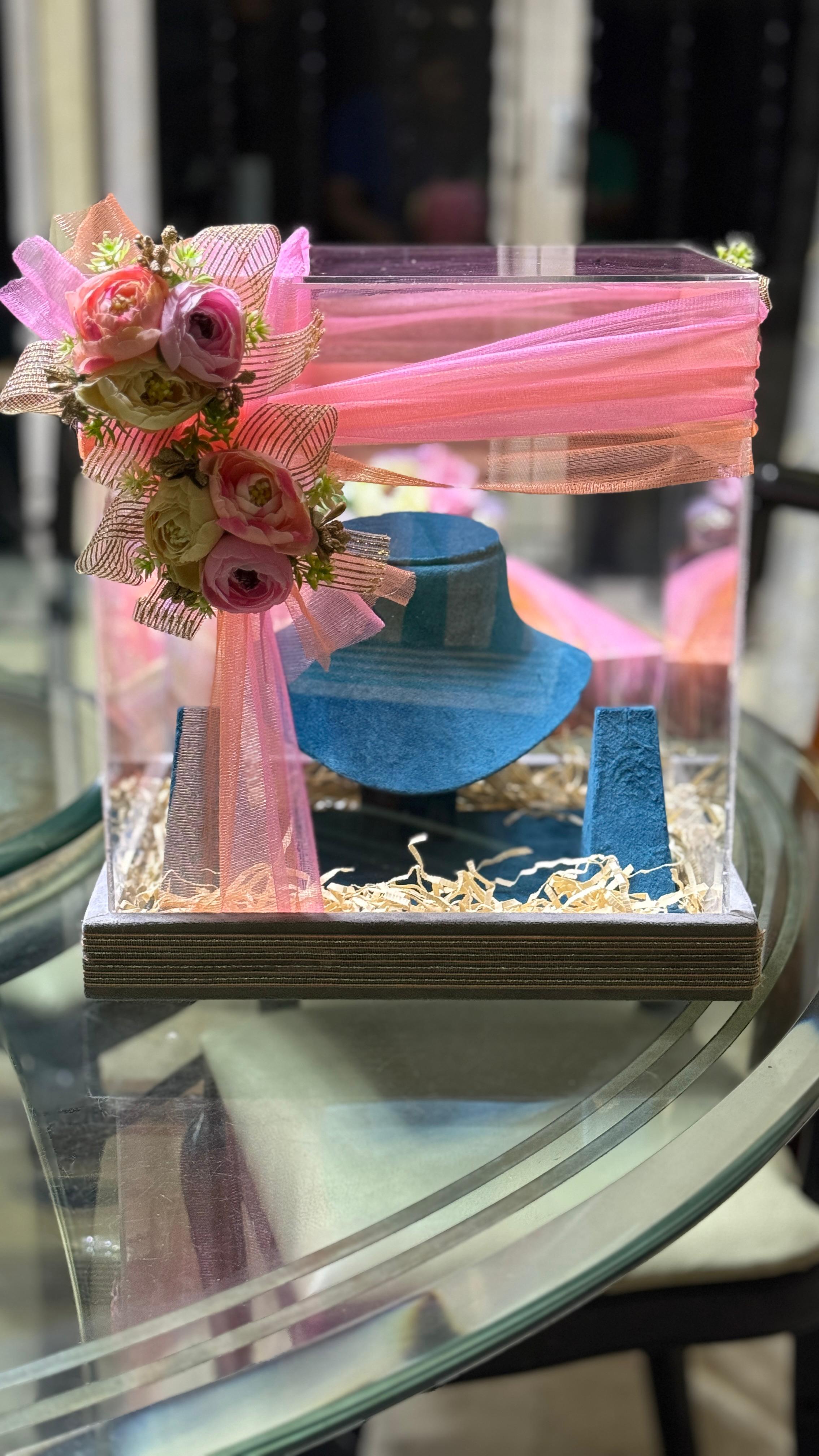 Transparent box with perfume bottle and pink tulle